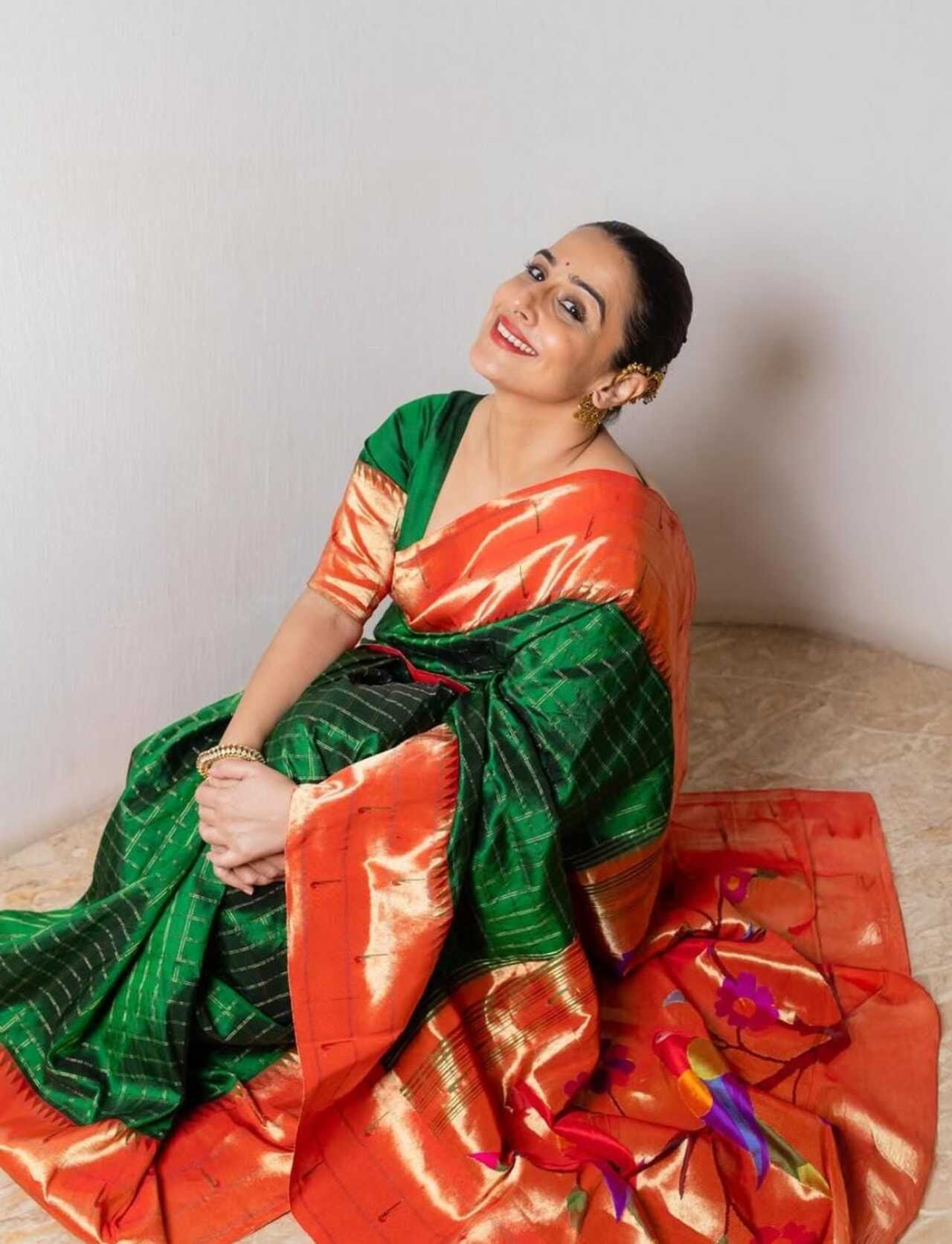 Vidya Balan embraces the richness of Paithani in a striking green saree with a contrasting orange pallu. The bold colour combination and intricate zari work reflect the true heritage of the weave. 